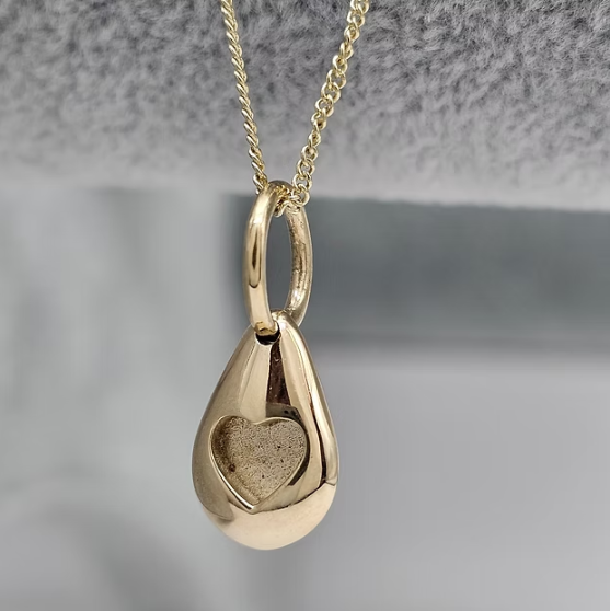 9ct yellow gold solid 3D pebble heart pendant side view showing heart bezel and loop bail on chain