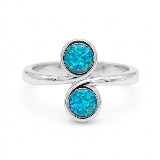 Illustrative sterling silver Swirl Duo memorial ring with blue teal opal flakes in both bezels