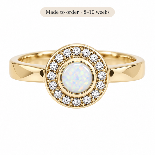 Illustrative gold Halo CZ Cluster memorial ring with pearl white opal resin