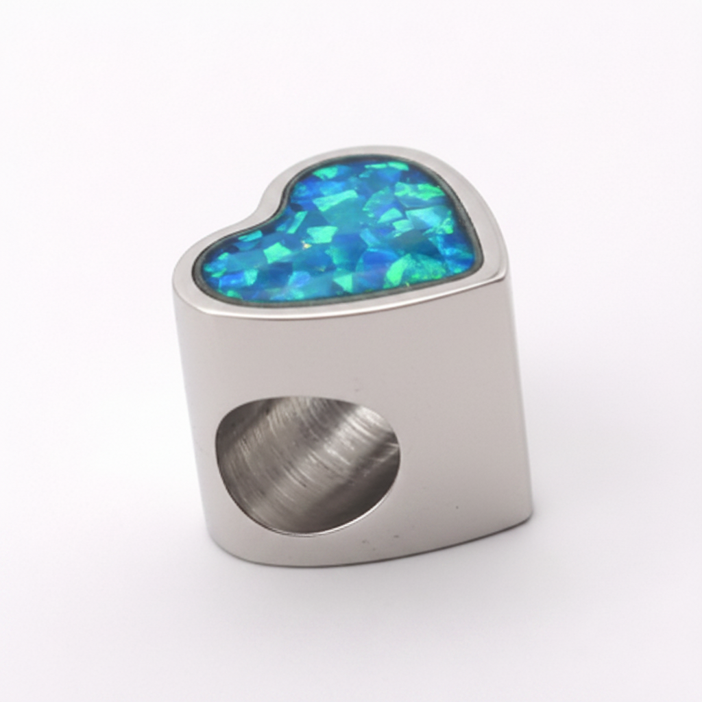 Stainless steel heart charm bead with blue teal opal flakes resin inclusion on white background