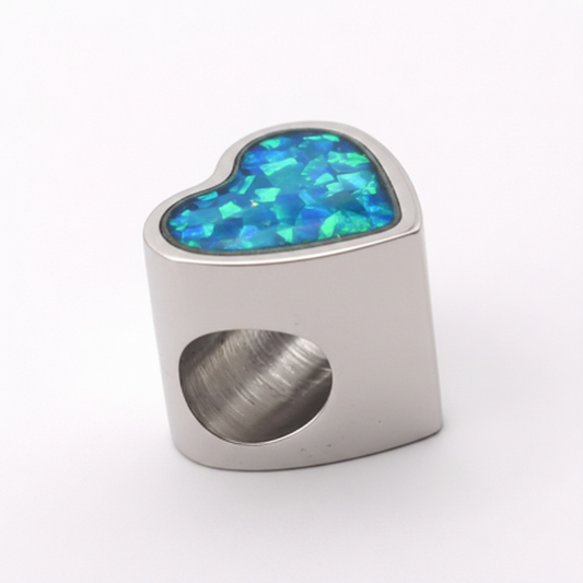 Stainless steel heart charm bead with blue teal opal flakes resin inclusion on white background