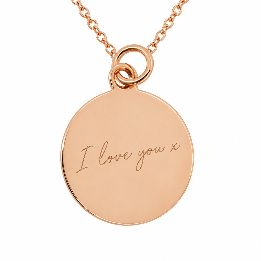 Illustrative engraved plain round rose gold pendant with matching chain on pure white background without cushions