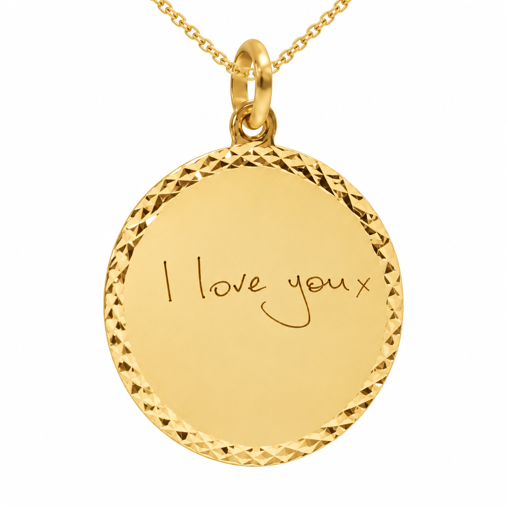 Illustrative handwriting engraved yellow gold 21mm round border pendant on chain, white background