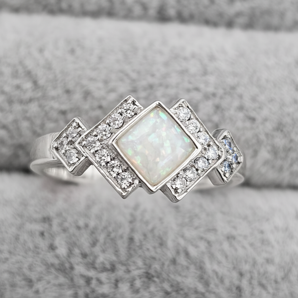 Art Deco CZ 925 silver ring with white pearl opal resin in diamond centre setting on white background