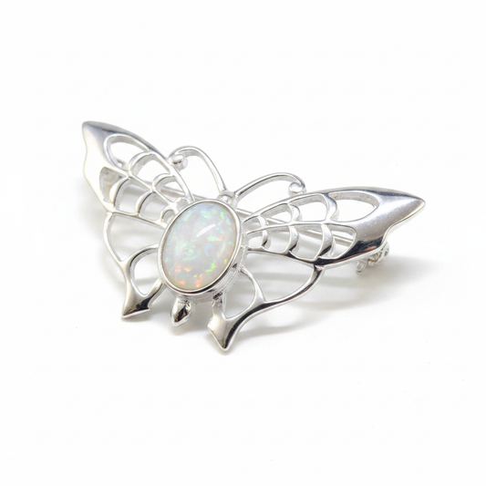 Silver 925 filigree butterfly brooch with white pearl opal resin in 8x6mm central bezel on white background