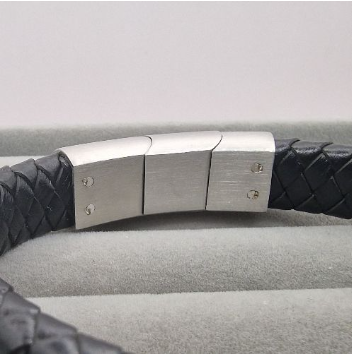 Close-up of brushed stainless steel sliding magnetic clasp on black leather memorial bracelet showing rectangle resin recess detail