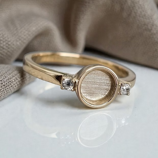 9K yellow gold round double gem CZ ring on white surface with linen — lifestyle shot