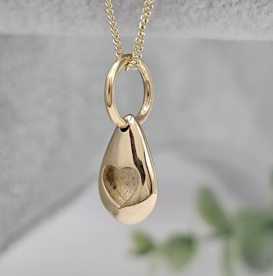 9ct yellow gold solid 3D pebble heart pendant front view showing heart bezel setting on chain