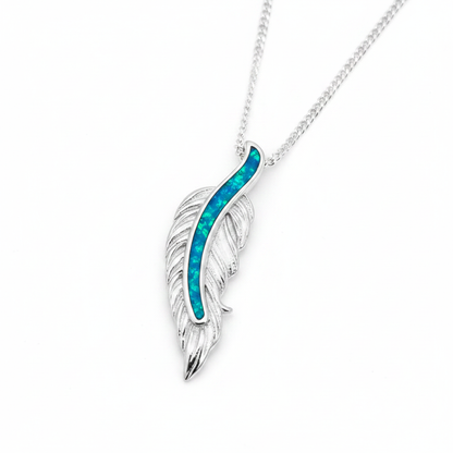 Floating feather silver pendant with blue teal opal resin spine channel, white background