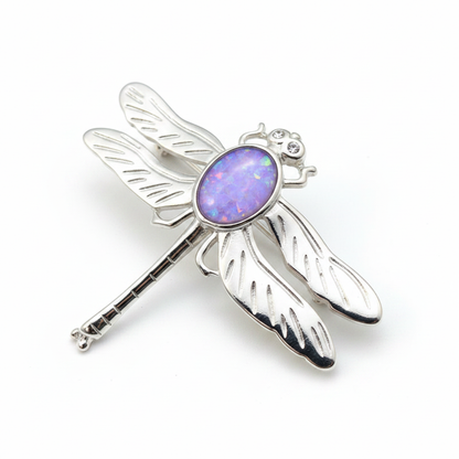 Silver 925 dragonfly brooch with lavender purple opal resin in 10x8mm central setting on white background