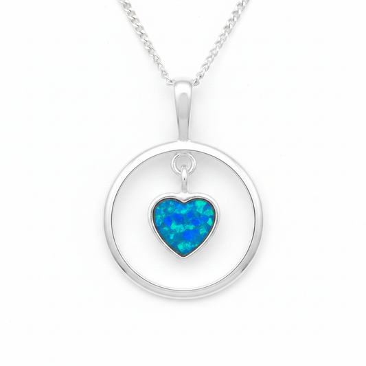 925 sterling silver circle pendant with floating heart bezel filled with blue teal opal flakes on white background