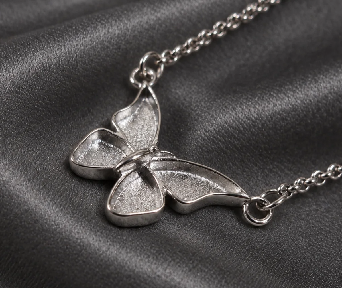 Angled view of the butterfly memorial necklace showing the wing recesses