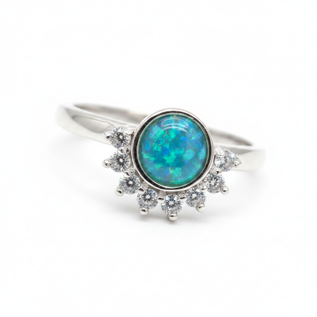 Round half halo CZ bezel 925 silver ring with blue teal opal resin centre on white background