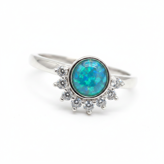 Round half halo CZ bezel 925 silver ring with blue teal opal resin centre on white background