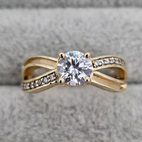 9ct yellow gold solitaire CZ infinity crossover band ring top view on grey velvet
