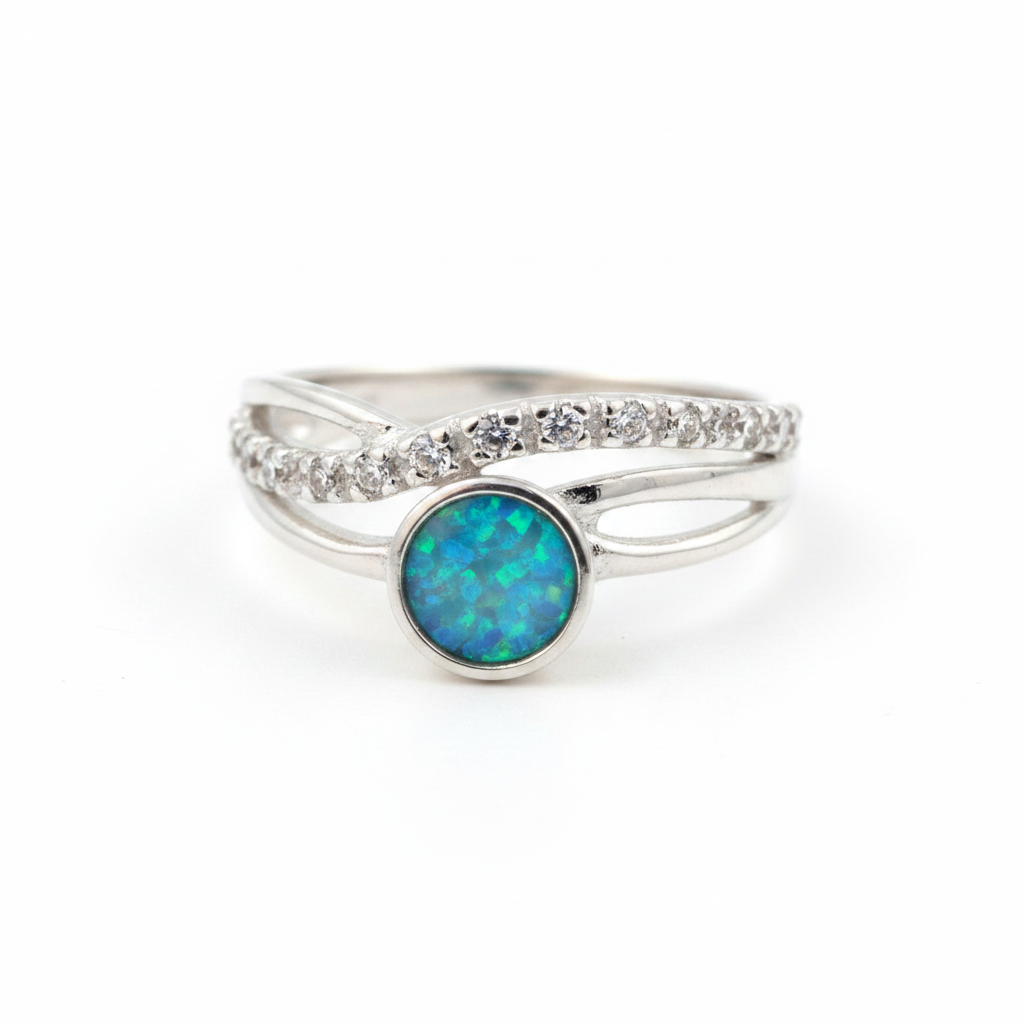 Silver 925 CZ crossover ring with blue teal opal resin in 5mm central setting on white background