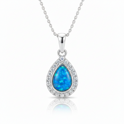 Silver 925 CZ halo teardrop memorial pendant with blue opal resin on chain, white background