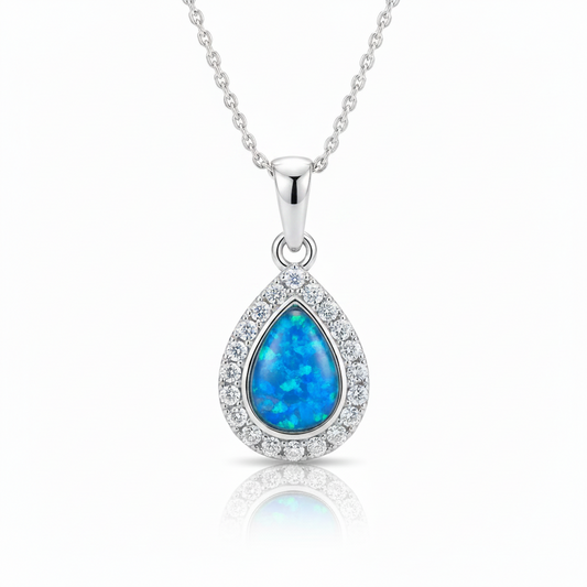 Silver 925 CZ halo teardrop memorial pendant with blue opal resin on chain, white background