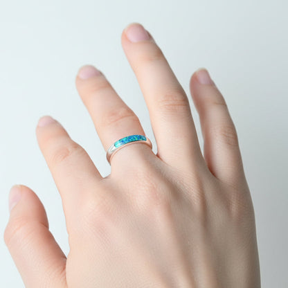Ladies silver channel ring with opals and ashes worn on hand, showing off the elegant fit and unique design.