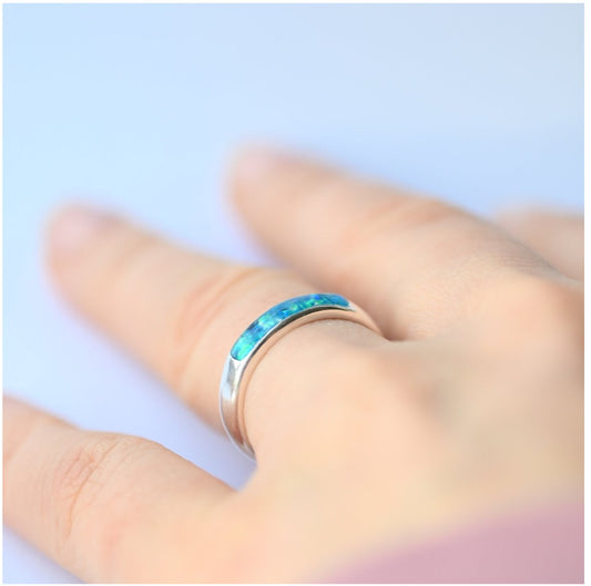 Ladies silver channel ring with opals and ashes, sparkling in natural light, perfect for a meaningful keepsake.