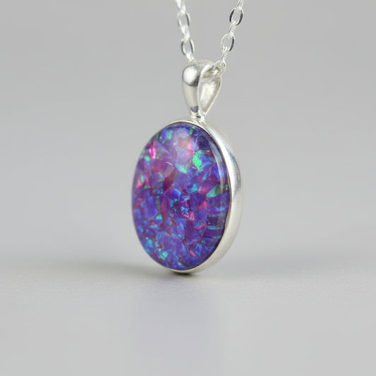Side View of Memorial Oval Pendant with Opal Flakes & Silver Chain – A side profile of the oval pendant, highlighting its opal flakes and attached to a sterling silver chain.