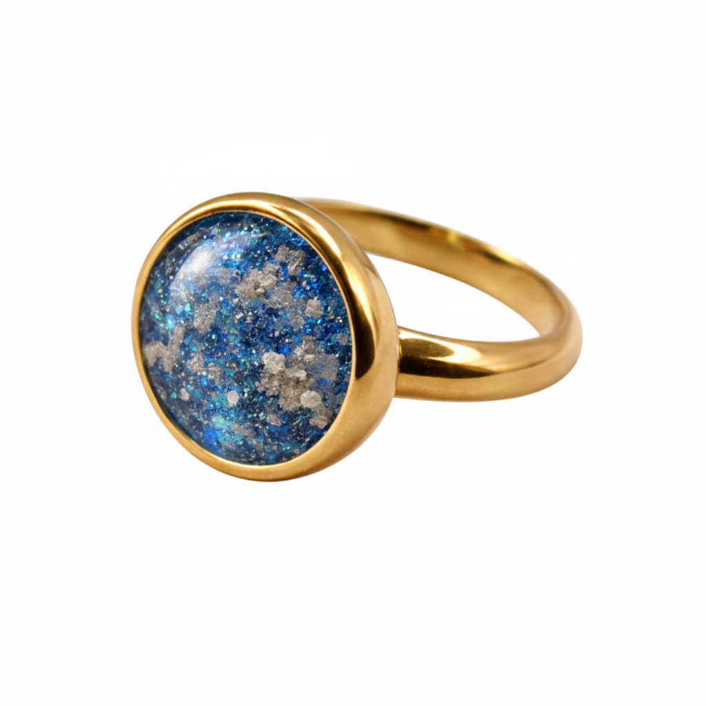 Gold ring with a blue gemstone on a light background
