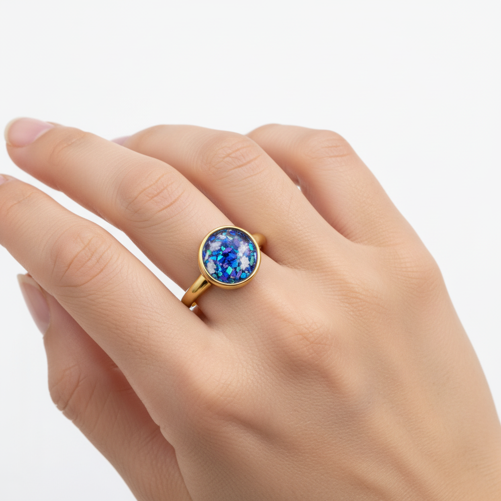 Gold ring with a blue and purple gemstone on a white background