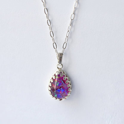 Close-up of Ashes and Opal Flakes in Teardrop Pendant – A zoomed-in shot of the teardrop pendant, showcasing the soft glow of opal flakes set within the ashes.