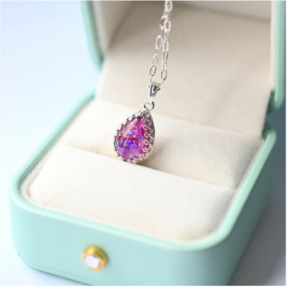 Teardrop Memorial Necklace with Ashes in Sterling Silver – A handcrafted sterling silver teardrop pendant holding cremation ashes and iridescent opal flakes, a timeless keepsake.
