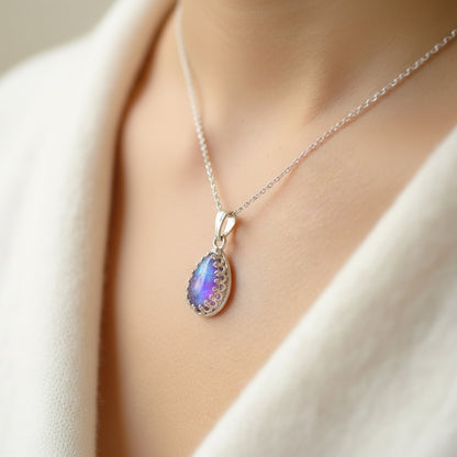 Close-up of Sterling Silver Teardrop Necklace with Ashes and Opal Flakes – A delicate teardrop pendant featuring preserved ashes and shimmering opal flakes, set in sterling silver.