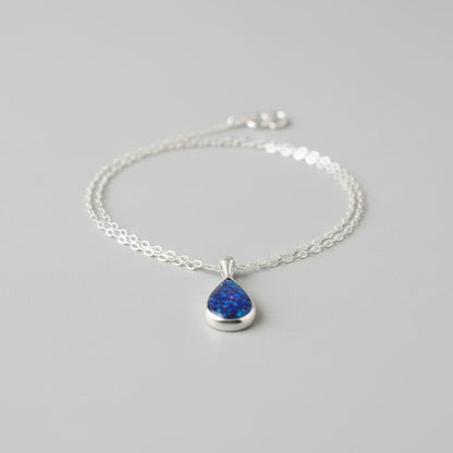 Teardrop Ashes Necklace in Sterling Silver with Opal Flakes – A handcrafted sterling silver teardrop pendant featuring cremation ashes and iridescent opal flakes, symbolising love and remembrance.